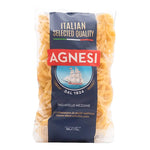 Dry Agnesi Tagliatelle Mezzane pasta in 500g package, showing golden, flat ribbon-shaped pasta strands on a white background.