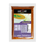 Jarome Rice Noodles Curry Paste 400g jar with label showing product name and brand, placed on a wooden surface.