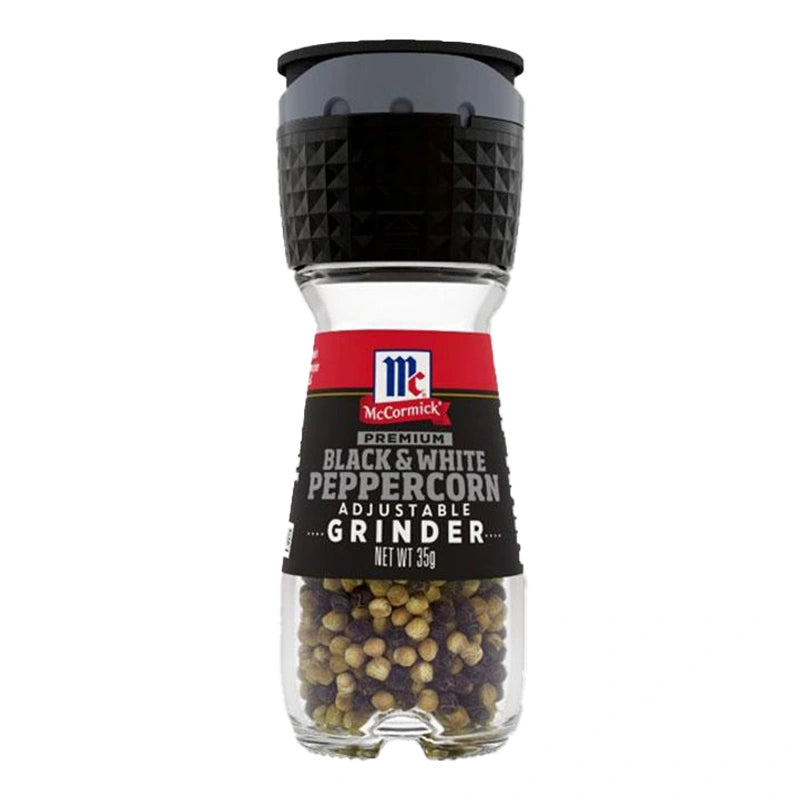 Close-up of MCCORMICK black and white peppercorns in a 35g jar, showing the mixed peppercorns with textured black and white surfaces.