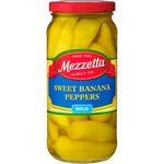 Cans of Mezzetta Sweet Peppers in a grocery store shelf, showcasing vibrant red and green peppers in clear glass jars.