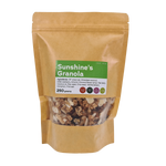 Sunshine Almond Dark Chocolate Granola in a bowl, showcasing crunchy granola with almonds and dark chocolate pieces.