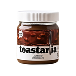 Toastaria almond chocolate spread jar with a spoon, showcasing creamy texture and rich chocolate and almond ingredients.