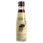 Bottle of Megachef soy sauce, healthy grocery product with dark, savory liquid in a clear glass bottle with a white cap.
