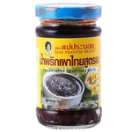Mae Pranom Vegetarian Thai Chili Paste in jar, showcasing vibrant red chili paste with fresh ingredients on a grocery store shelf.