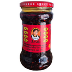 Laoganma chili paste with fermented ingredients in a jar, popular Chinese grocery condiment for adding spice and flavor.