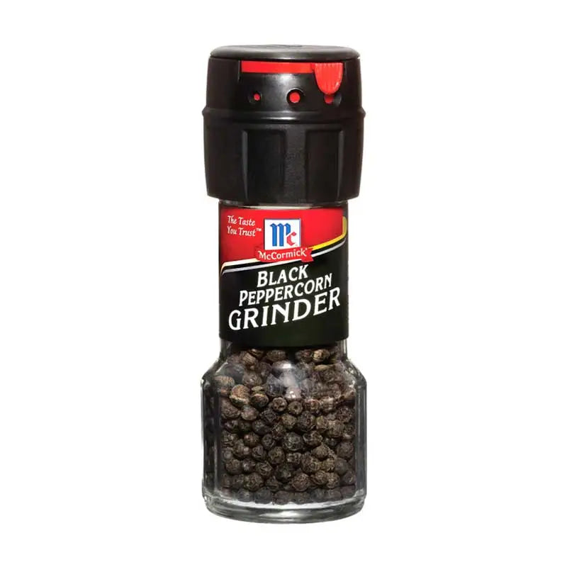 Ground black pepper in a 28g MCCORMICK spice jar, showing the black pepper grains and label on the jar.