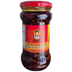 Laoganma Spicy Minced Chicken Chili in a jar, ready to add flavor to dishes, with visible chili flakes and minced chicken inside.