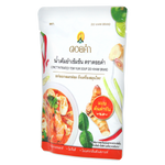 Close-up of Daikham Concentrated Tom Yum Soup in a jar, showcasing the label and rich red color of the Thai soup concentrate.