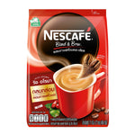 Nescafe Blend and Brew instant coffee mix in a jar, showcasing rich aroma and a scoop of coffee powder on a wooden surface.