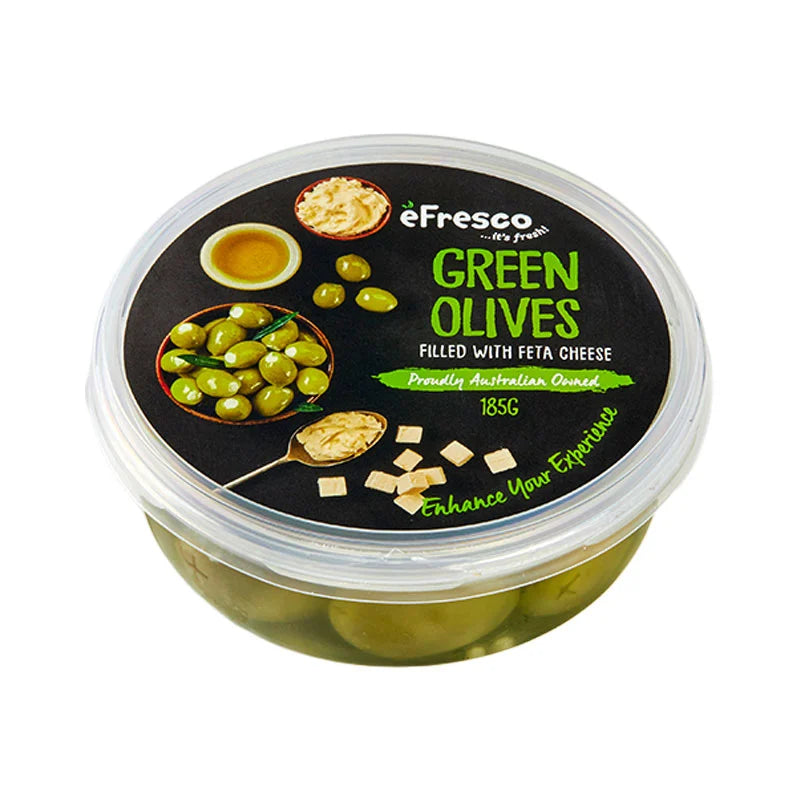 Makro green olives with feta cheese in a clear bowl, showing the vibrant green olives and crumbled feta on top.