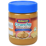 Jar of McGarrett Crunchy Peanut Butter with visible textured peanut pieces on the label and spoonful of peanut butter showing crunchy texture