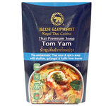 Blue Elephant Tom Yam Soup in a bowl, showcasing vibrant herbs, chili, and shrimp in a flavorful Thai grocery product.