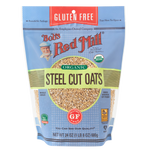 Bob's Red Mill gluten-free steel cut oats in a clear glass jar with a scoop, ready for breakfast or cooking.