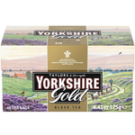 Taylors Yorkshire Gold Tea drink in a glass with a tea bag, showcasing the rich, golden color of the brewed tea.