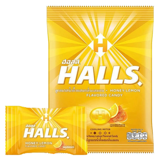 HALLS Honey Lemon flavored candies in a clear bowl, showing individually wrapped lemon and honey-flavored lozenges.