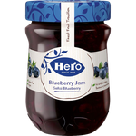 Hero Blueberry Jam jar with a blue label and fresh blueberries around it, showcasing the grocery product.