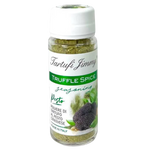 Jar of Tartufi Jimmy Truffle Pesto Spice with fresh basil and truffle pieces, used as a flavorful seasoning for dishes.