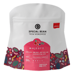 Aroma Majesty Blend drink in a clear glass, showcasing its vibrant, colorful liquid with a fresh citrus garnish.