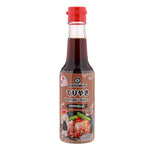 Kikkoman Tasty Teriyaki sauce bottle, soy-based condiment for cooking and glazing, with a label featuring the Kikkoman brand logo.
