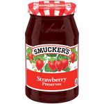Jar of Smucker's Strawberry Preserves with a spoonful on a plate, showcasing the glossy, vibrant strawberry jam.