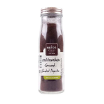 Ground smoked paprika from Spice Story, vibrant red spice in a glass jar, used to add smoky flavor to dishes.
