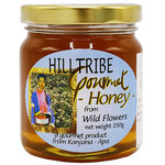 Jar of Hilltribe Gourmet Wild Honey from the grocery collection, showcasing golden honey with a rustic label.