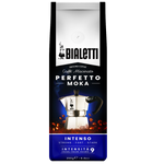 Bialetti Intenso coffee drink in a glass cup with a frothy top and coffee beans beside it, showcasing the rich beverage.