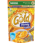 Nestle Gold Honey Flakes cereal in a bowl with milk, showing golden flakes and honey flavor details.