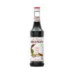 Bottle of MONIN Chai Tea Syrup in 700ml container, showing the label and dark caramel color of the syrup inside.