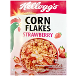 Bowl of Kelloggs Strawberry Cornflakes cereal in a white bowl with fresh strawberries and milk on a wooden table.