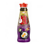 Takumi Soyu Japanese soy sauce bottle in a grocery setting, showcasing the Takumi brand and typical packaging.