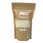 Radiance Wholefoods desiccated coconut in a grocery bag, showing shredded coconut with a natural, fluffy texture.