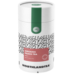Northlandtea Organic Peach Black Tea drink in a clear glass with peach slices and tea leaves visible.