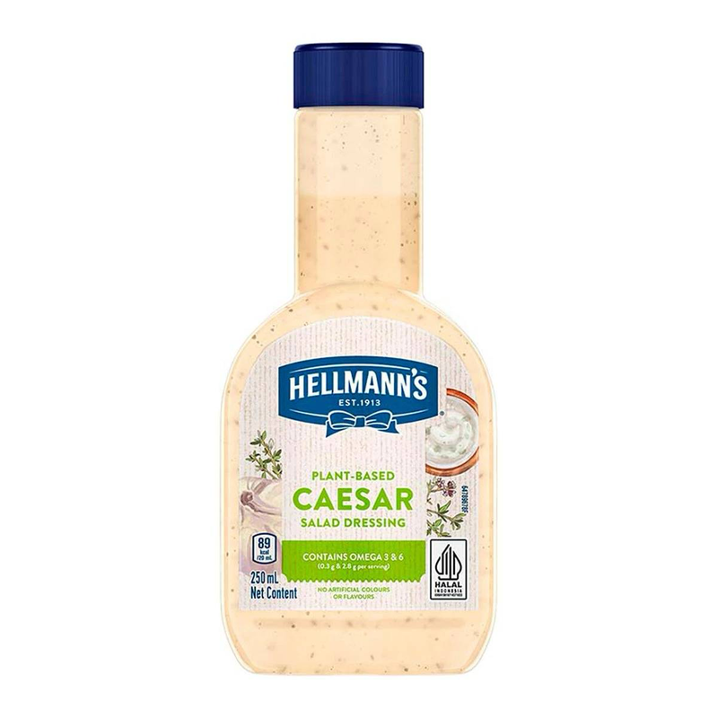 Bottle of Hellmann's Plant-Based Real Caesar Salad Dressing showing the label and salad ingredients inside the transparent bottle.