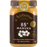 Airborne Manuka Honey Active AAH 85+ jar with honey drizzling from the spoon, showcasing the product's rich, golden texture.