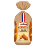 Golden St Michel Madeleines vanilla-flavored confectionery snacks arranged on a plate, showcasing their soft texture and buttery appearance.