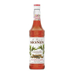 Bottle of MONIN Cinnamon Syrup 700ml for dry grocery, showing the label and dark cinnamon-colored liquid inside the bottle.