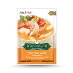 Kanokwan Tom Yum Paste jar, a Thai grocery product with red and yellow label, ready for cooking spicy and sour Tom Yum soup.
