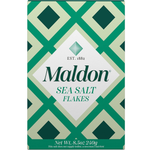 Maldon Sea Salt Flakes in a clear jar, showcasing white flaky salt crystals, ideal for seasoning and finishing dishes.