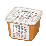 Marukome Plus Koji Miso additive-free dry grocery product with miso paste in a clear package, showcasing its natural ingredients.