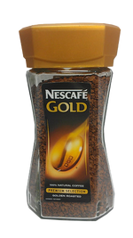 A cup of Nescafe Gold coffee drink with a frothy top, showcasing the rich, golden color of the coffee in a clear glass.
