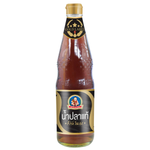 Healthy Boy Premium Fish Sauce bottle, savory Asian grocery condiment with a red label and clear glass container.