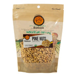 Close-up of Baboo Pine Nuts confectionery snacks in a clear package, showcasing the small, golden pine nut treats.