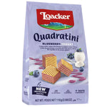 Loacker Quadratini Blueberry Yogurt wafer cookies stacked, showing blue and white packaging with blueberry and yogurt flavors.