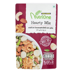 Nutrione Hearty Mix confectionery snacks in a colorful bowl with nuts, dried fruits, and chocolates on a white background.