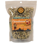 A glass of Baboo Chrysanthemum Flower Tea with fresh chrysanthemum flowers and tea leaves, showcasing the vibrant floral drink.