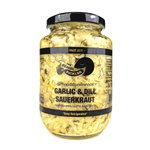 Jar of The Serial Pickle Garlic and Dill Dauerkraut with fresh garlic and dill, showcasing its tangy, fermented flavor.