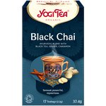 A cup of Yogi Black Chai tea in a mug, showcasing the rich dark color of the brewed chai beverage.