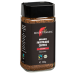 Mount Hagen Organic Fairtrade Instant Coffee drink in a cup, showcasing rich coffee color and packaging.