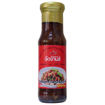 Jadjans Stir Fried Basil Sauce in a jar, featuring fresh basil and herbs, ideal for enhancing Asian-inspired dishes.